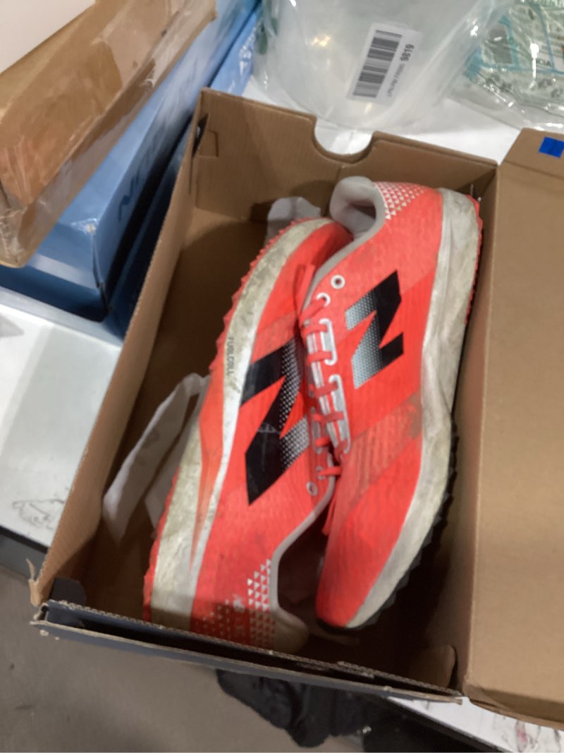 Condition photo showing As Is for new balance unisex adult fuelcell xc7 v5 cross trainer shoes 11.5 wide women/10 men urgent red/black/white
