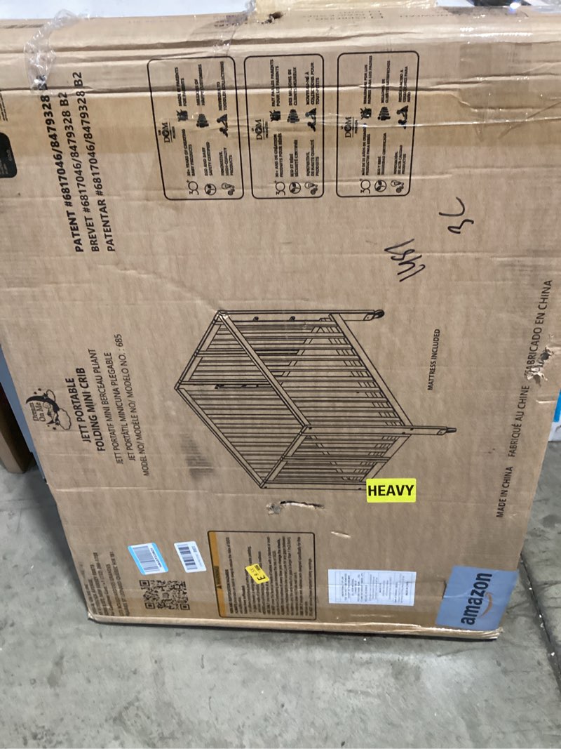 Condition photo showing New/Like New for dream on me jett mini folding baby crib in white, greenguard gold & jpma, lightweight & portable, patented flat folding system for small spaces & travel, 1.5” mattress pad, 3 heights, safe wheels