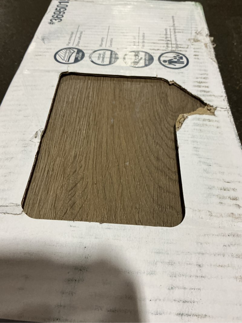 Condition photo showing As Is for style selections brunette oak 7-in wide x 5-mm thick waterproof interlocking luxury vinyl plank flooring (23.36-sq ft)