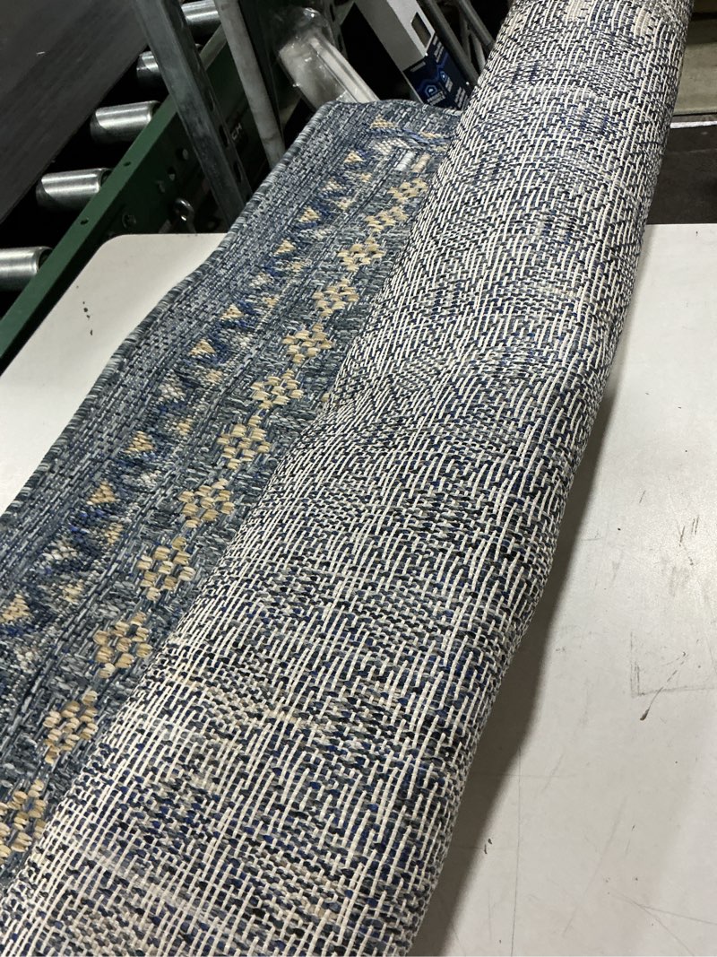 Condition photo showing As Is for allen + roth blue border tile 5 x 7 (ft) loomed polypropylene blue rectangular indoor/outdoor border hose washable pet friendly area rug