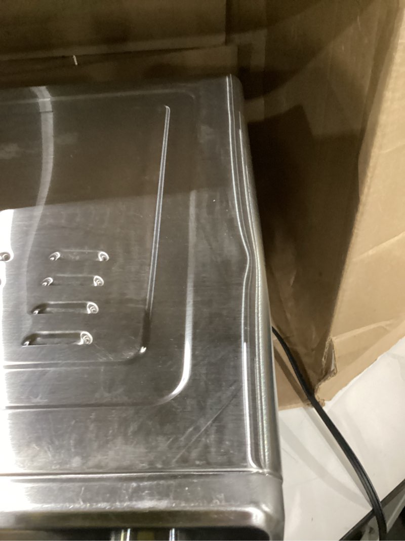 Condition photo showing As Is for top has dent used not tested dan - emeril lagasse extra large french door air fryer toaster oven combo, 24 cooking functions and digital controls, 7 accessories included, stainless steel finish, 26qt capacity