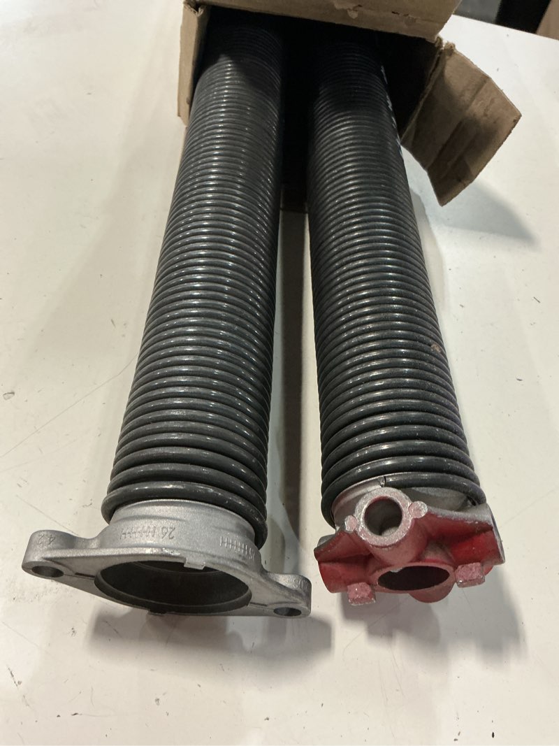 Condition photo showing As Is for 0.207 in. wire x 2 in. d x 25 in. l torsion springs in yellow left and right wound pair for sectional garage doors