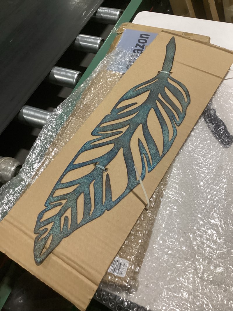 Condition photo showing As Is for **broken** (one feather is broken)retrome 27\" h metal cross wall decor, arrow accents, bronze………