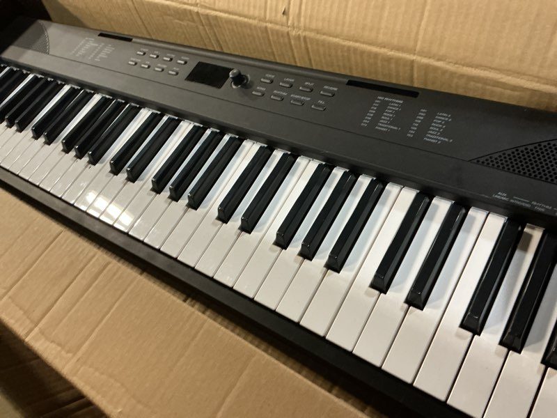Condition photo showing As Is for Alesis 88 Key Keyboard Piano with 480 Sounds, Speakers, USB MIDI, Carry-Bag, Stand, Headphones, Pedal and Piano Lessons for Beginners with Accessories