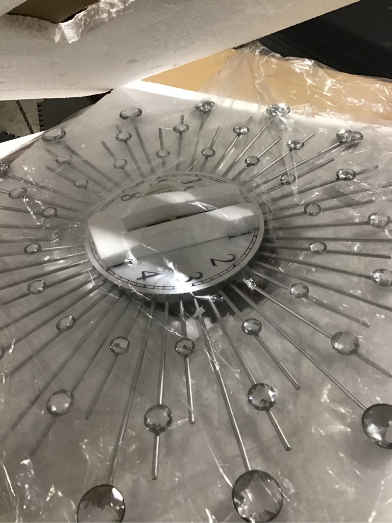 Condition photo showing As Is for Lafocuse 23 Inch Silver Large Wall Clock for Living Room Décor, Modern Starburst Decorative Wall Clo