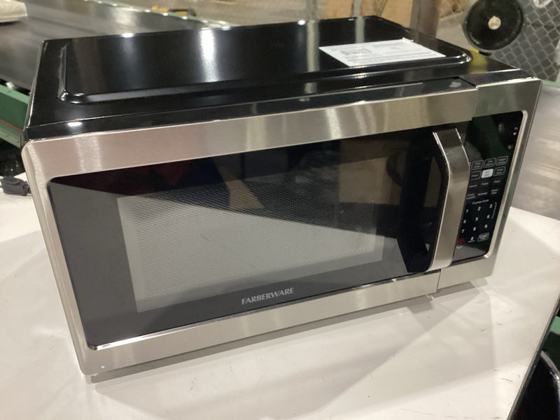 Condition photo showing As Is for **door closes but does not latch**  farberware 0.7 cu. ft. countertop microwave oven – 700 watts power, auto cook settings, defrost, easy clean and child safety lock - stainless 0.7 cu. ft. stainless steel