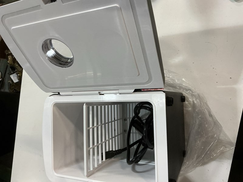 Condition photo showing As Is for frigidaire retro 9-can mini personal fridge portable cooler for car, office, bedroom, dorm room, or cabin, 11.8" d x 7.1" w x 10.1" h, black