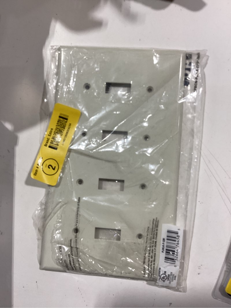Condition photo showing As Is for Eaton 4 -Gang Midsize Size Light almond Polycarbonate Indoor Toggle Wall Plate