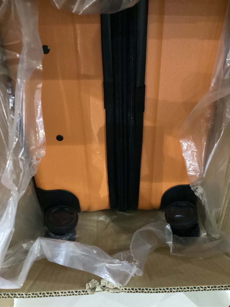 Condition photo showing item condition for Amazon Basics 30" Hardside Large Checked Luggage, Hardshell Suitcase With Wheels, Expandable For Up to 15% More Space, With Scratch-Resistant Surface, Four Multi-directional Wheels, Orange Orange Large Checked