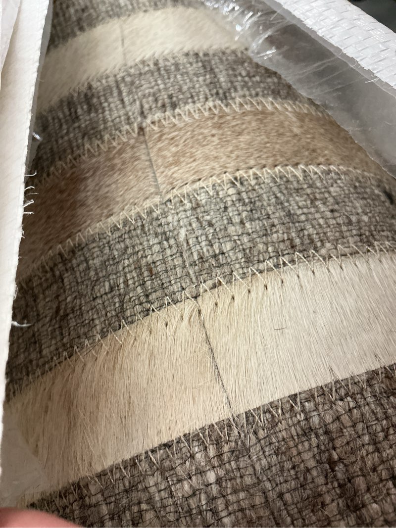 Condition photo showing As Is for geometric hair on hide rug 9’