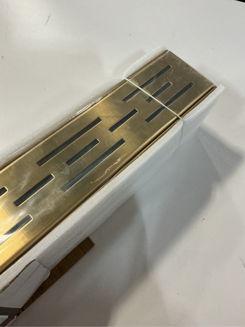 Condition photo showing Good Condition for Neodrain 24-in Brushed Brass Rectangular Linear Shower Drain with Brick Pattern Grate, 304 Stainless Steel Bathroom Floor Drain, Gold Linear Drain with Hair Strainer,CUPC Certified Golden 24 In