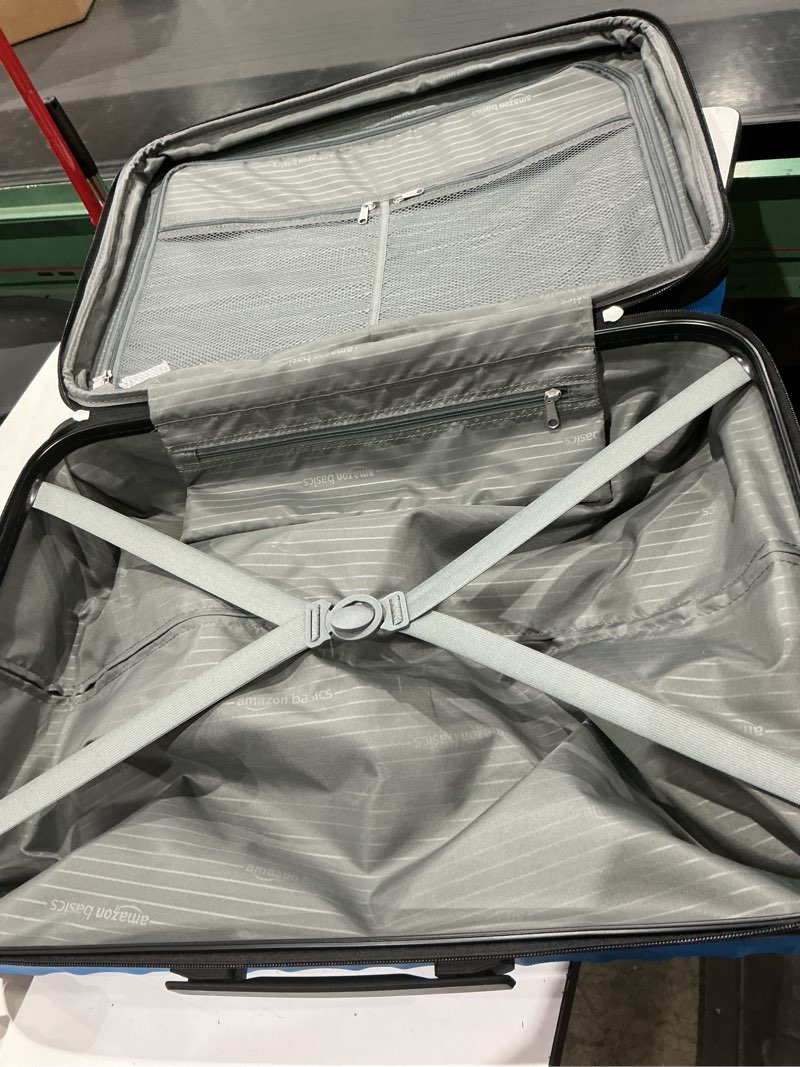 Condition photo showing Good Condition for amazon basics hardside large checked luggage, expandable for up to 15% more space, with scratch-resistant surface, four multi-directional wheels, telescoping handle, light blue light blue large checked (we don’t know size )