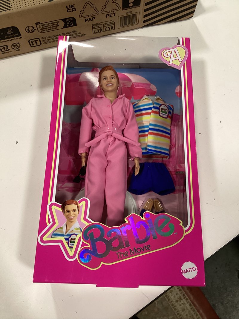 Condition photo showing New/Like New for Barbie The Movie Allan Collectible Doll, Michael Cera as Allan with 2 Removable Movie Fashions, Pink Jumpsuit Outfit & Blue Striped Beach Set with Sunglasses
