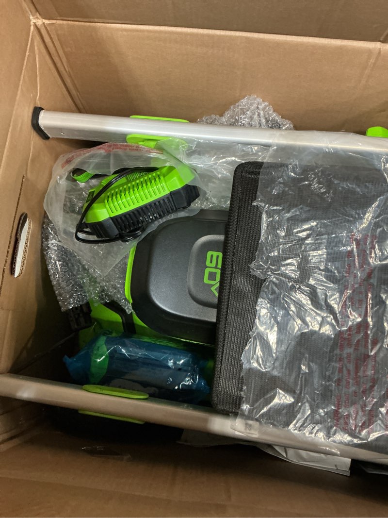 Condition photo showing As Is for 60v 21" cordless battery dual blade self-propelled mower, (1) 8ah battery and 6a charger, lm2146s