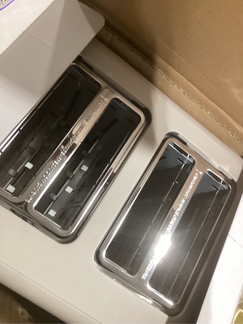 Condition photo showing New/Like New for bella 4 slice toaster, 6 setting shade control with reheat & cancel buttons, removable crumb tray, anti jam & auto shutoff, 900 watt, oatmilk
