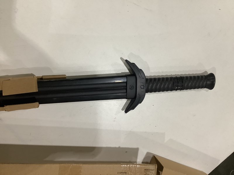 Condition photo showing As Is for black plastic sword