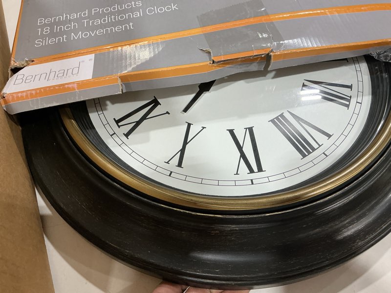Condition photo showing As Is for bernhard products extra large wall clock, 18 inch, dark brown, quartz silent, battery operated, non-ticking, decorative roman numeral, stylish clock, accurate timekeeping