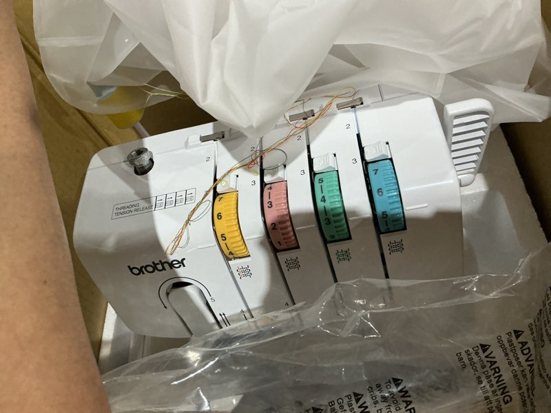 Condition photo showing As Is for brother serger, 1034d, heavy-duty metal frame overlock machine, 1,300 stitches per minute, removeable trim trap, 3 included accessory feet, white
