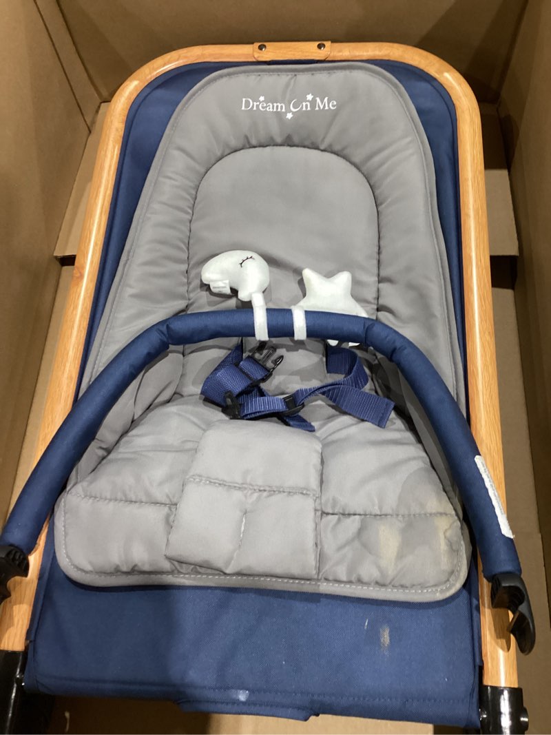 Condition photo showing As Is for dream on me rock on me 2-in-1 baby rocker and stationary seat, adjustable recline, gentle music & vibration, 3-point safety harness, detachable toy bar, folds compact for travel – blue
