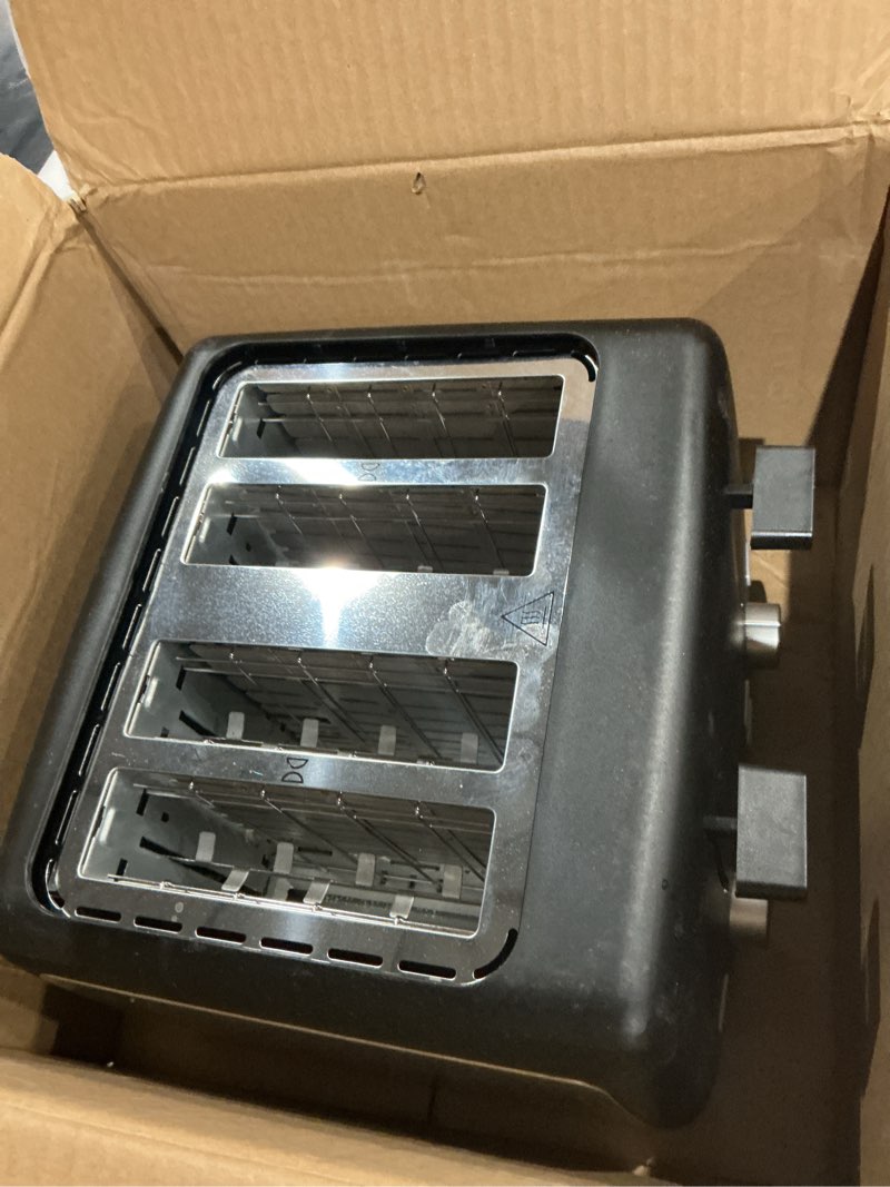 Condition photo showing As Is for amazon basics 4 slice toaster, with 7 browning settings, extra wide slots for bagels and special breads, removable easy-to-clean crumb trays, cancel/defrost/bagel buttons, 1500w, black & silver 4 slice matte black front