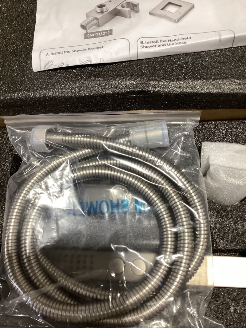 Condition photo showing Good Condition for all-metal high pressure square handheld shower head with jet spray and rainfall modes, volume control regulator, on/off switch, hose and wall mounted adjustable bracket (brushed nickel)
