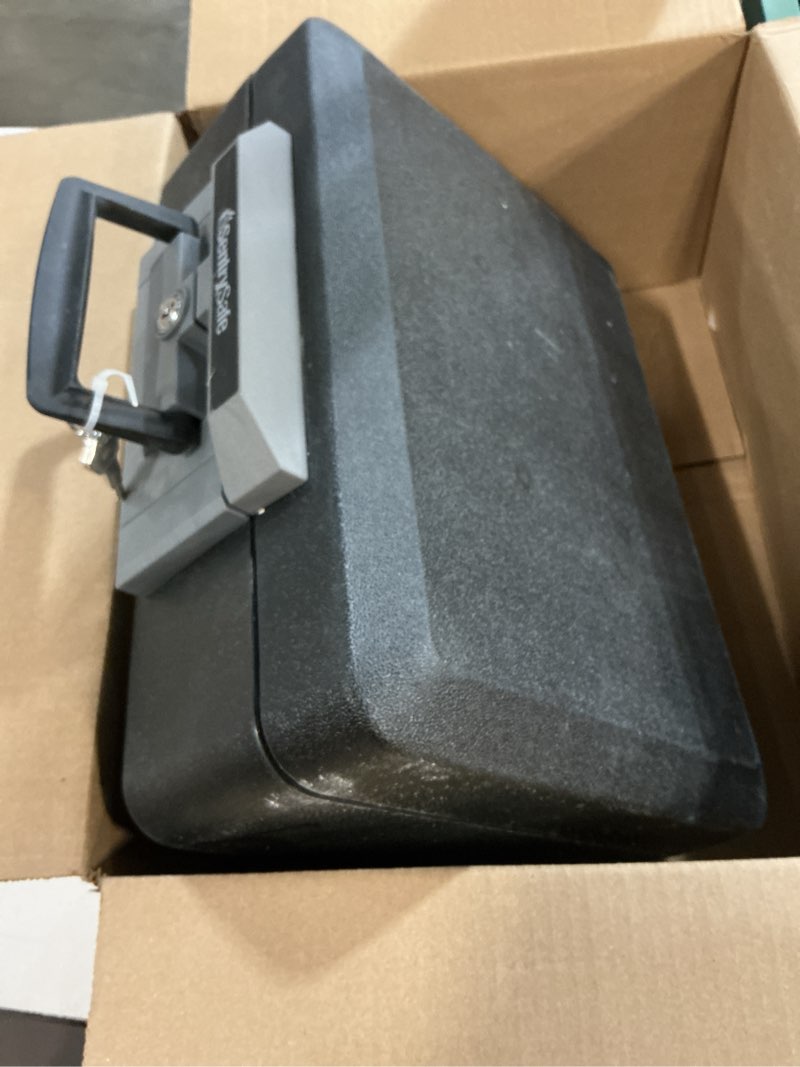 Condition photo showing As Is for sentrysafe fireproof safe box with key lock, chest safe with carrying handle to secure money, jewelry, documents, 0.25 cubic feet, 6.3 x 15.3 x 12.1 inches, 1160 fire resistant box 0.25 cu. ft.
