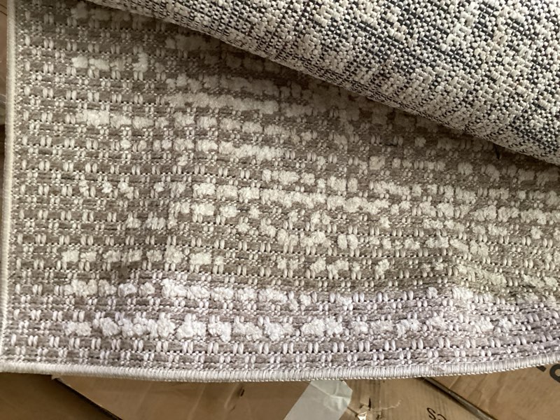 Condition photo showing As Is for loloi amber lewis bexley collection bex-02 taupe/natural 7'-10" x 10' area rug neutral, textured, living, bedroom, dining, carpet taupe / natural 7'10" x 10' (rectangular)