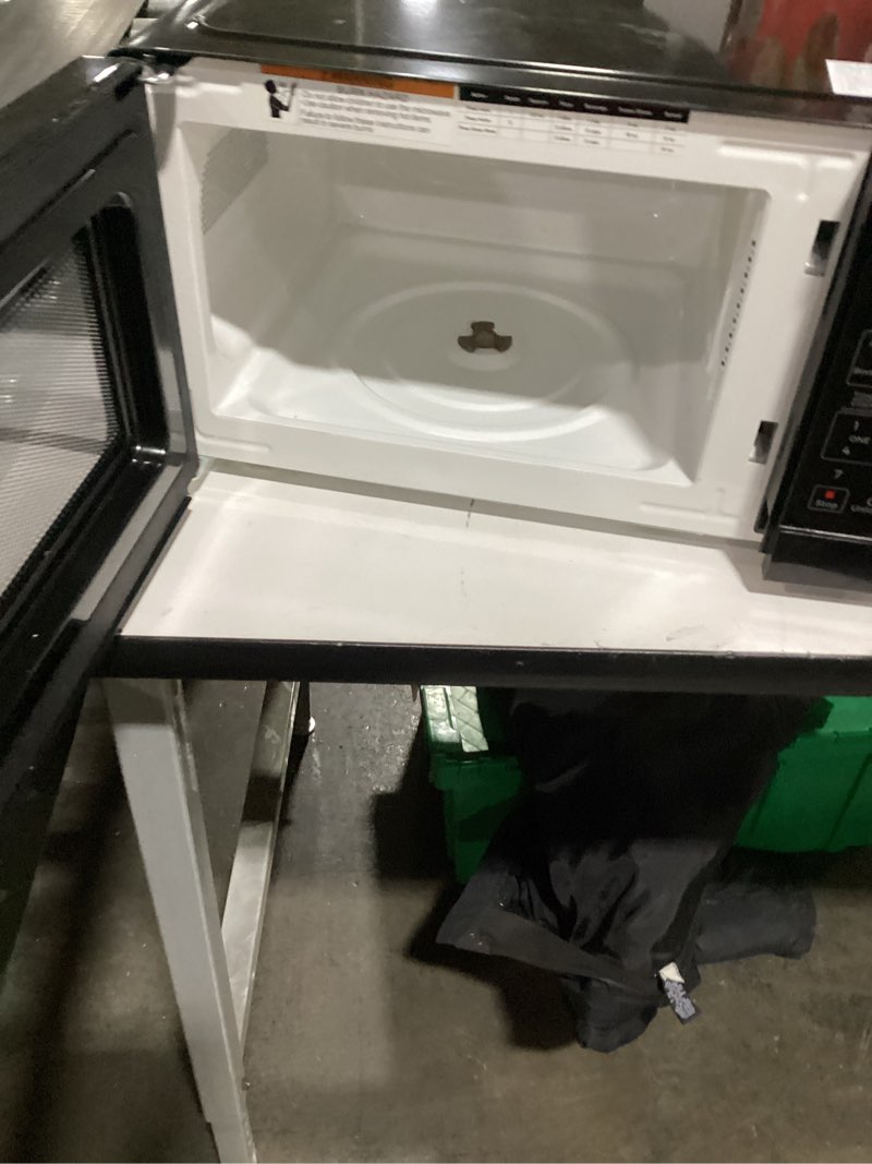 Condition photo showing As Is for **Incomplete **( missin glass tray and roller)\ nCountertop Microwave Oven 0.7 Cu. Ft., 700 Watts with 10 Power Levels, 6 Cooking Presets with One-Touch Express Cook, Eco Mode, Child Safety Lock, & Mute Button - Black
