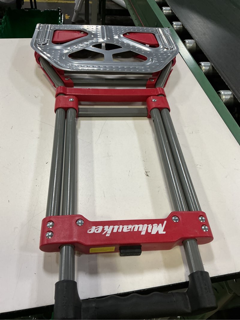 Condition photo showing As Is for milwaukee 150-lb capacity 2 -wheel red steel folding hand truck