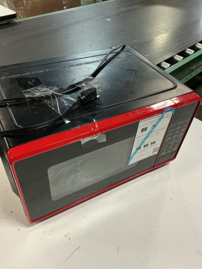Condition photo showing As Is for mainstays 0.7 cu ft countertop microwave oven, 700 watts, red