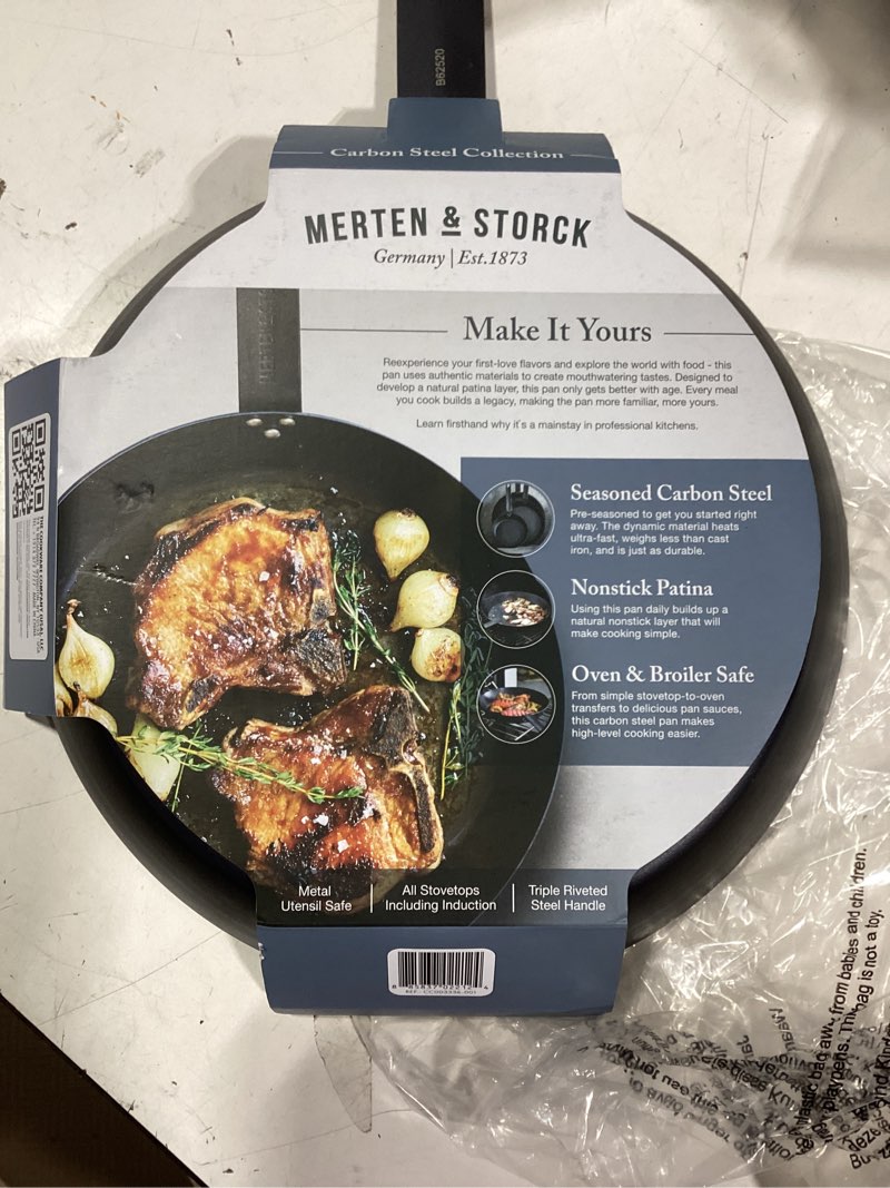 Condition photo showing As Is for merten & storck pre-seasoned carbon steel 10” frying pan skillet, use on induction, stove and grill, durable, even-heating, for searing, grilling, oven use, and campfire, indoor/outdoor 10" frying pan skillet black