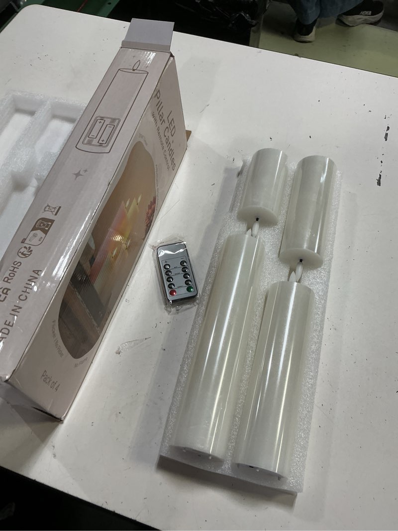 Condition photo showing New/Like New for  set of four led pillar candles with a remote control
