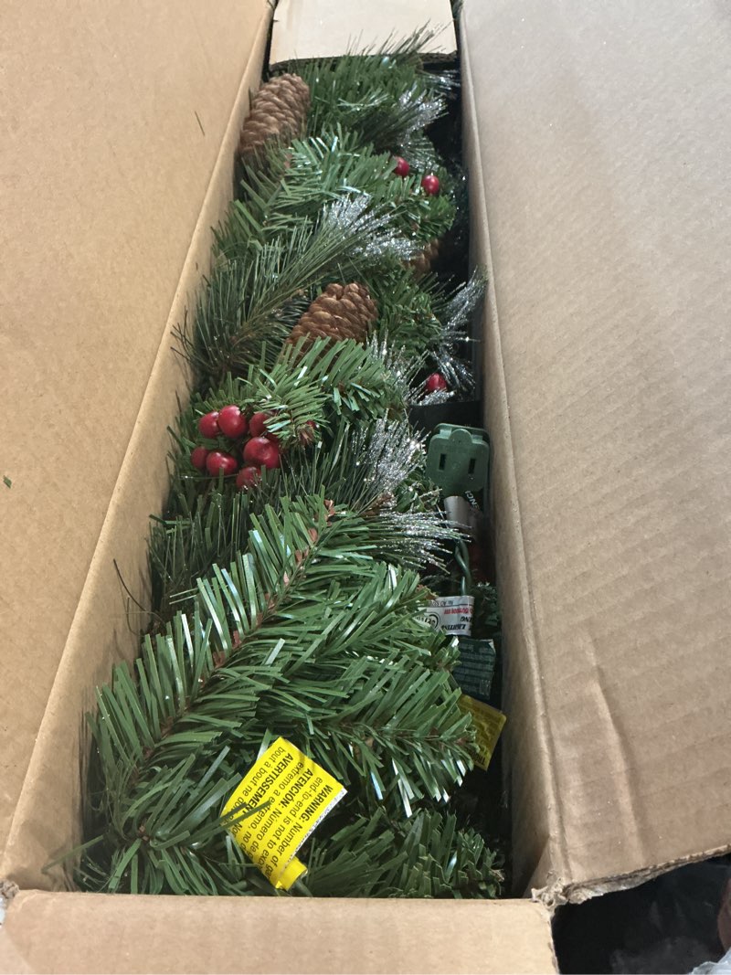 Condition photo showing Good Condition for National Tree Company 9 ft Pre-Lit Crestwood Spruce Artificial Christmas Garland, Christmas Decoration with Glitter, Pinecones, Red Berries, 50 Clear Lights, 180 Tips, Green Plug In Tree