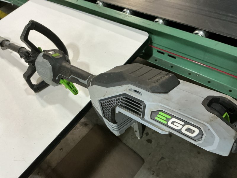 Condition photo showing As Is for ego power+ mhc1603 multi-head combo kit 16-inch 56-volt carbon fiber string trimmer with powerload & 8-inch carbon fiber edger attachment & 56-volt power head, 4.0ah battery and 320w charger included combo carbon fiber combo kit, w/4.0ah battery