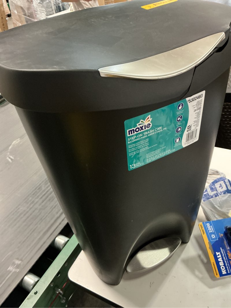 Condition photo showing As Is for moxie 13-gallon black plastic indoor kitchen step trash can