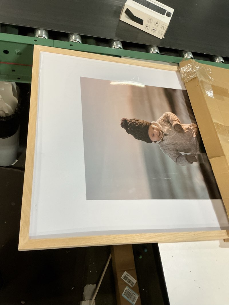Condition photo showing item condition for Homeforia A2 Picture Frame Natural Wood, High End Oak 16.5 x 23.4 Wooden Poster Frames Matted to 11.7 by 16.5 Photo, A2 Size Light Wood Frames with Tempered Glass, Wall Kit,  of 1