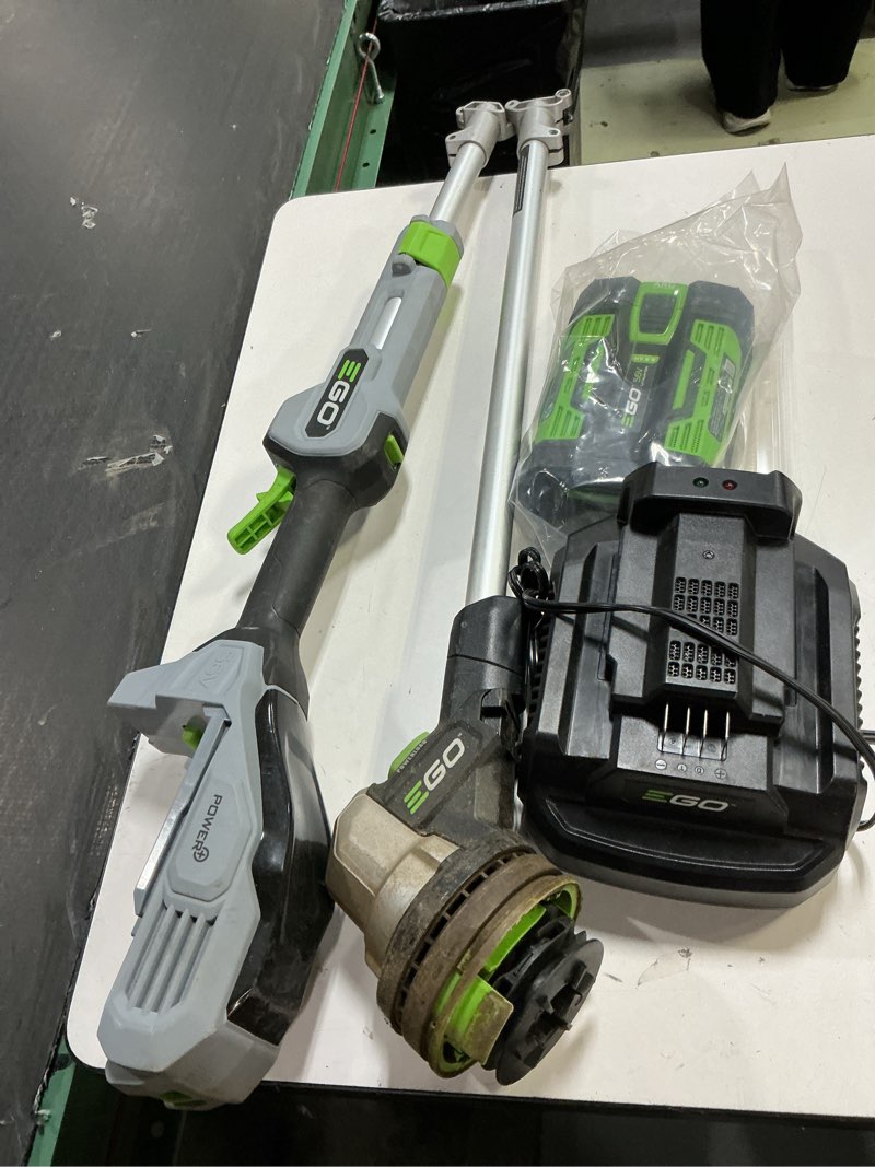 Condition photo showing As Is for ego power+ string trimmer, battery powered, 15" trimmer for weeds and grass with rapid reload, split shaft, includes 56v 2.5ah battery and charger - st1502sa w/2.5ah battery, rapid reload