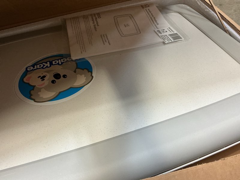 Condition photo showing As Is for koala kare surface-mounted horizontal baby changing station, model kb300-01 (grey)