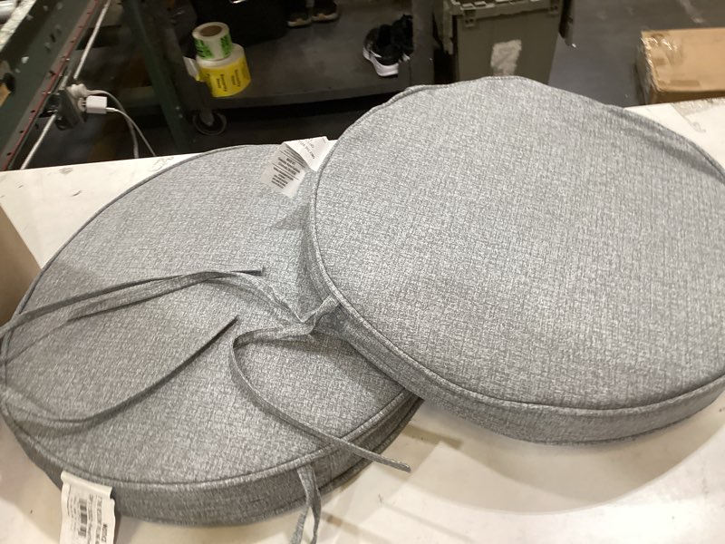 Condition photo showing As Is for greendale home fashions 18  x 18  heather gray round outdoor chair pad (set of 2)
