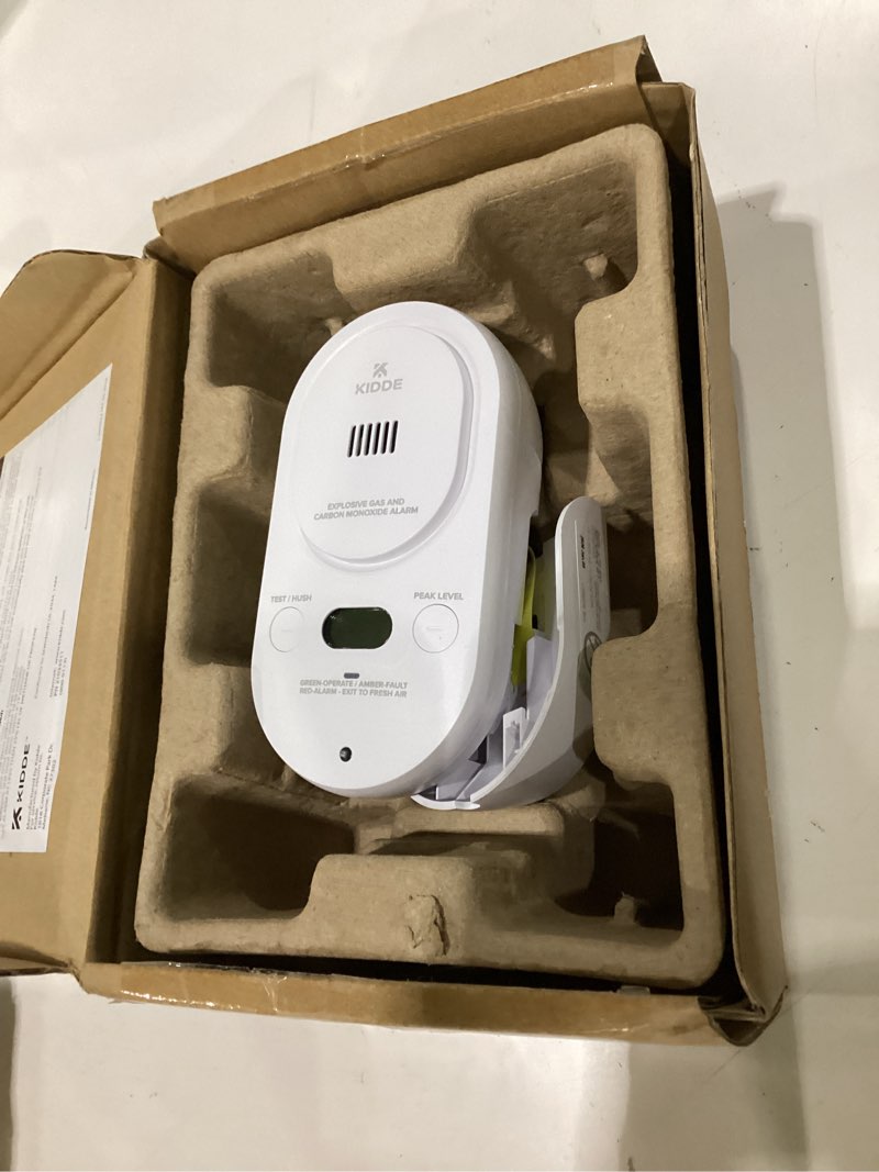 Condition photo showing As Is for kidde carbon monoxide + explosive gas, natural gas & propane alarm, plug-in with 9v battery backup, digital display, 85 db alarm, led status indicators, 3rd edition 1 pack 3rd edition