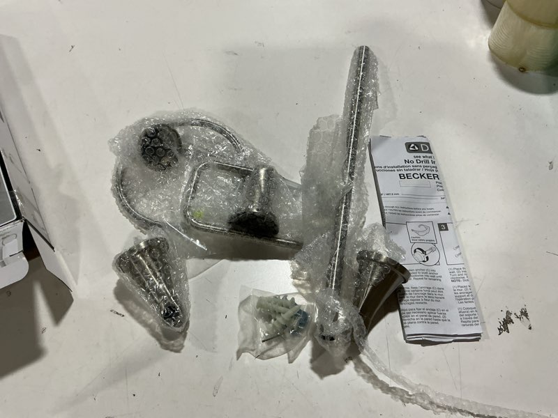 Condition photo showing As Is for Delta Faucet Becker 3-Piece Bathroom Set, SpotShield Brushed Nickel, 18"/24" Towel Rack, Toilet Paper Holder, Ring BCK63-DN