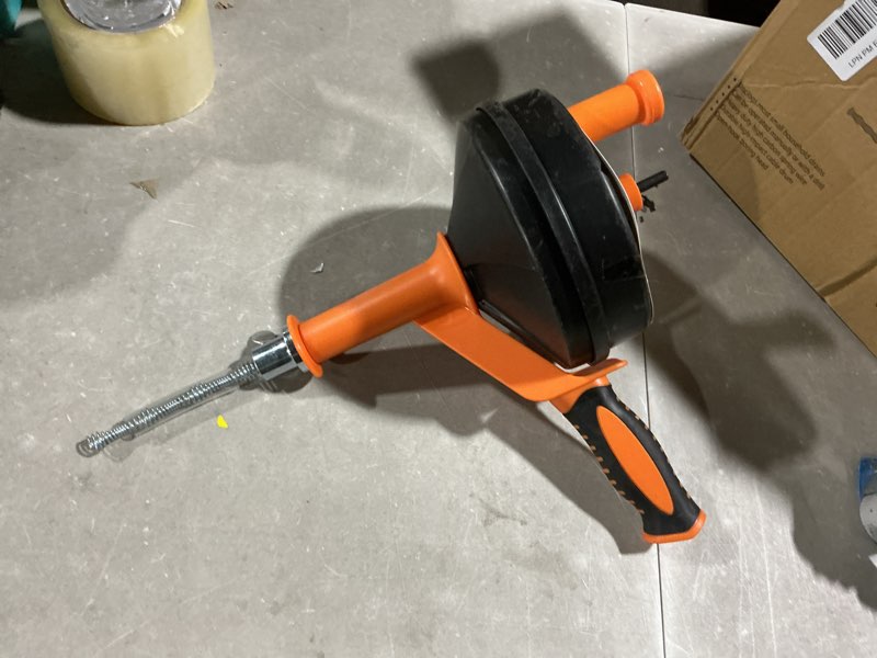 Condition photo showing As Is for drain auger, clog remover with drill adapter, 25 feet flexible plumbing snake use manually or powered for kitchen, bathroom and shower sink, comes with gloves (orange)