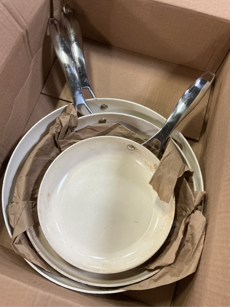 Condition photo showing As Is for amazon basics ceramic nonstick cookware, 3-piece set of pans, all cooktop friendly, dishwasher-safe, ivory