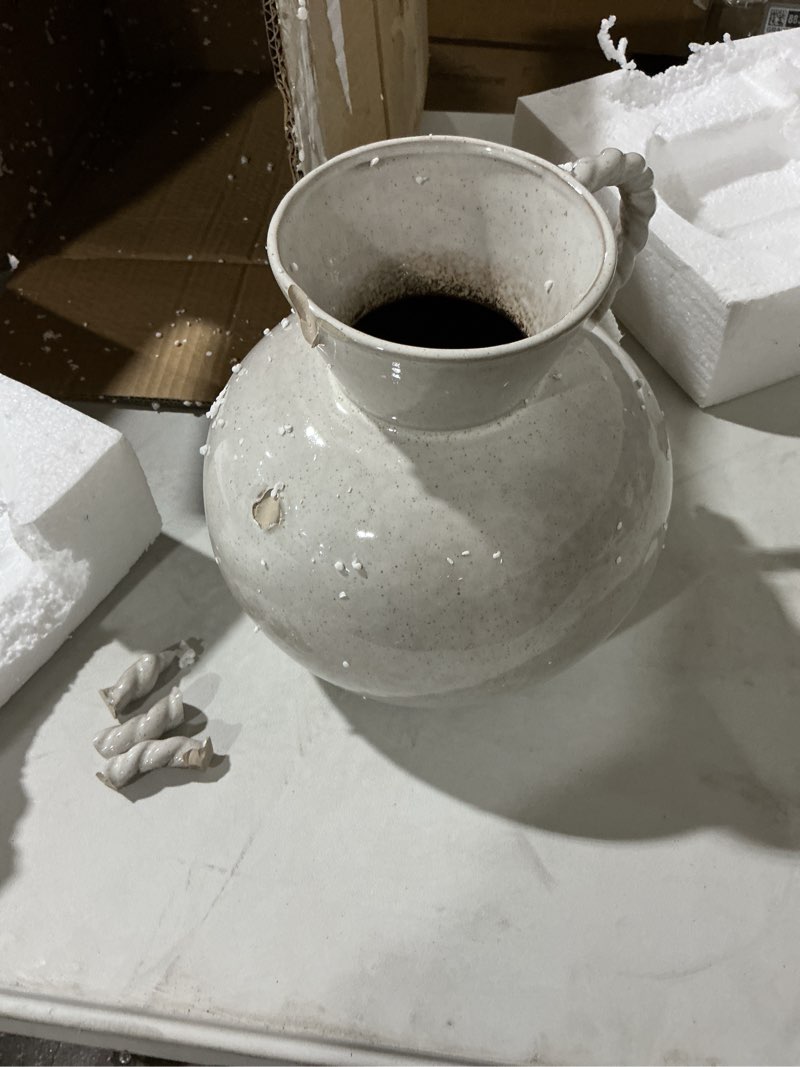 Condition photo showing As Is for 9.25 inches stoneware vase with twisted handles and reactive glaze, cream color