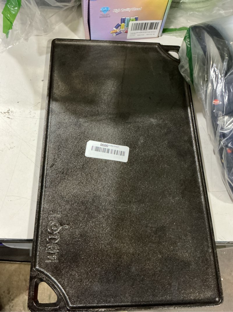 Condition photo showing As Is for lodge reversible cast iron grill/griddle pan 16.75 x 9.5 - pre-seasoned dual-sided double burner for bbq, eggs, pancakes, burgers - pfas free cookware - flat top plate for oven, grill, & campfire 16.8" x 9.5" x 0.8" double burner grill