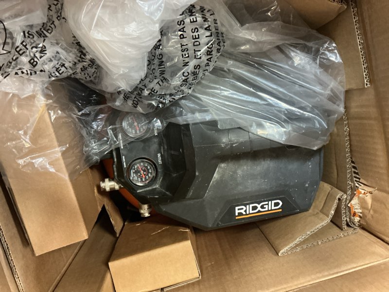Condition photo showing As Is for 6 gal. 150 psi portable electric oil-free jobsite pancake air compressor with 25 ft. air hose and 18ga brad nailer