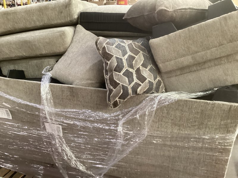 Condition photo showing As Is for Signature Design by Ashley Stonemeade Casual Right-Arm Facing Sofa Chaise with Reversible Cushion and 4 Toss Pillows, Light Brown