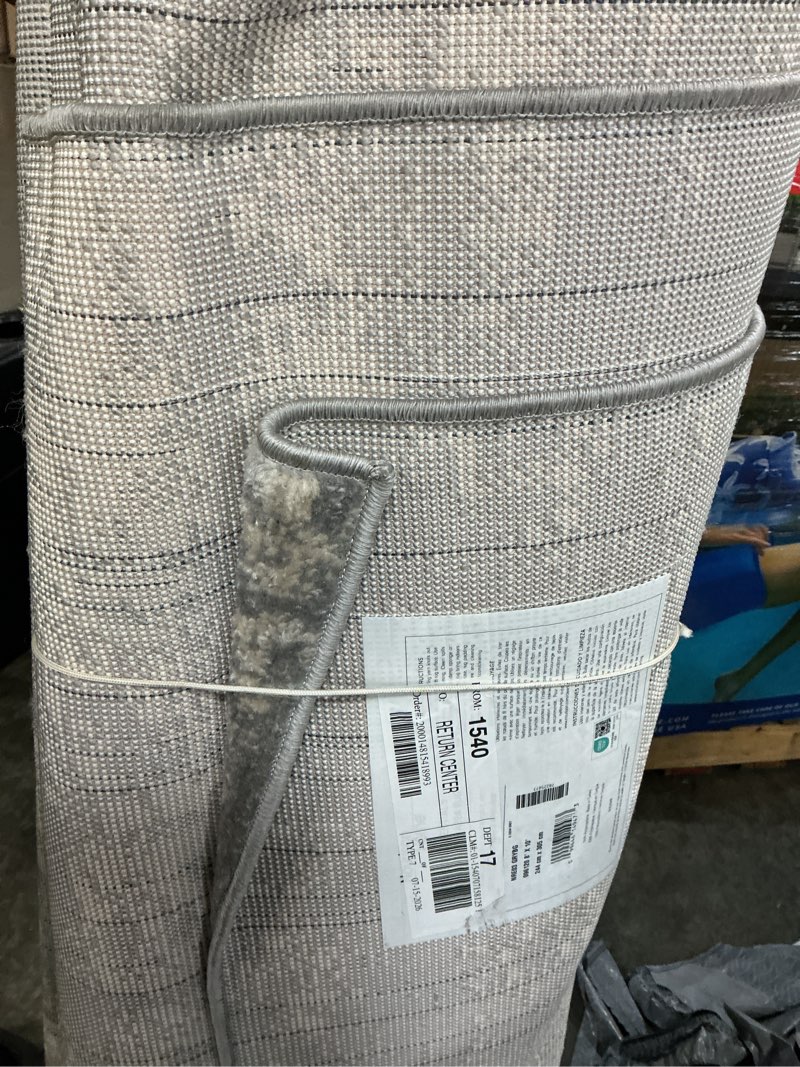 Condition photo showing As Is for nourison essentials 8 x 10 (ft) grey/beige indoor/outdoor abstract area rug