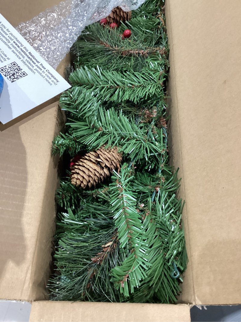 Condition photo showing Good Condition for national tree company 9 ft pre-lit crestwood spruce artificial christmas garland, christmas decoration with glitter, pinecones, red berries, 50 clear lights, 180 tips, green plug in tree