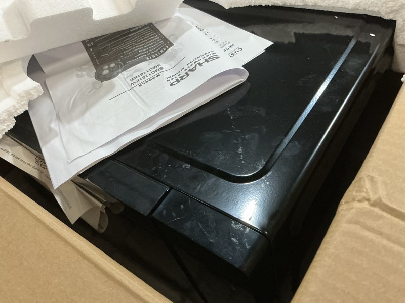 Condition photo showing As Is for sharp countertop microwave oven with removable 12.4" carousel turntable, 1000 watt, 1.1 cubic feet, black